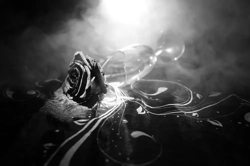 Broken,Wineglass,And,Wilted,Rose,On,Dark,Background.,A,Wilting